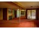 Basement featuring a fireplace, wood paneling, and sliding glass doors at 962 S Beech St, Lakewood, CO 80228