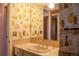 Bathroom featuring a vintage style sink, countertops, lighting and wallpaper at 962 S Beech St, Lakewood, CO 80228