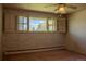 Bedroom features a window with bright, natural light and neutral wall color and carpet at 962 S Beech St, Lakewood, CO 80228