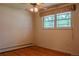 A bright bedroom features hardwood floors and a ceiling fan at 962 S Beech St, Lakewood, CO 80228
