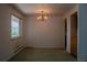 An inviting dining room with a classic chandelier and a window at 962 S Beech St, Lakewood, CO 80228