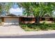 Charming brick ranch home with a large garage and driveway, surrounded by lush greenery at 962 S Beech St, Lakewood, CO 80228