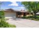 Charming brick home with a two-car garage, mature trees, and a spacious driveway at 962 S Beech St, Lakewood, CO 80228