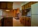 Kitchen with retro wood cabinets, vintage appliances, and open access to the living room at 962 S Beech St, Lakewood, CO 80228