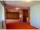 Spacious living room with a fireplace, wood paneling, and natural light from the window at 962 S Beech St, Lakewood, CO 80228