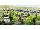 A tranquil neighborhood with varied homes nestled among verdant trees against a backdrop of rolling hills at 962 S Beech St, Lakewood, CO 80228