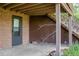 Covered patio with brick accents and potential for outdoor relaxation and entertainment at 962 S Beech St, Lakewood, CO 80228