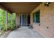 Spacious covered patio with brick siding, perfect for outdoor gatherings and relaxation at 962 S Beech St, Lakewood, CO 80228