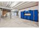 Unfinished basement with storage cabinets and carpeted area at 8885 S Tibet Ct, Aurora, CO 80016