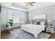 Spacious main bedroom with bay window, plush carpet, and ceiling fan at 8885 S Tibet Ct, Aurora, CO 80016