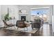 Cozy living room featuring a fireplace and large windows at 8885 S Tibet Ct, Aurora, CO 80016