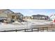 Snow-covered street with houses, showcasing a quiet community at 8885 S Tibet Ct, Aurora, CO 80016