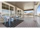 Covered porch with wood flooring and comfortable seating at 8885 S Tibet Ct, Aurora, CO 80016