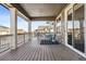 Spacious covered porch with wood flooring and view of neighborhood at 8885 S Tibet Ct, Aurora, CO 80016