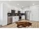 Modern kitchen featuring stainless steel appliances and white cabinets, offering a clean and stylish design at 2851 W 52Nd Ave # 208, Denver, CO 80221