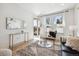 Bright living room featuring large windows, modern decor, and access to an outdoor balcony at 2851 W 52Nd Ave # 208, Denver, CO 80221
