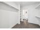 Bright walk-in closet with custom shelving and rods, adjacent to a well-lit bathroom at 2851 W 52Nd Ave # 208, Denver, CO 80221