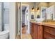 Bathroom featuring a vessel sink, wood vanity, and stylish sconces at 3946 Perry St, Denver, CO 80212