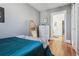 Comfortable bedroom featuring hardwood floors, a white dresser, and a view to the hallway at 3946 Perry St, Denver, CO 80212