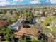 Beautiful aerial view showcases a neighborhood with lush greenery and mountains in the distance at 2250 S Zang Ct, Lakewood, CO 80228