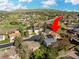 Listing home shown in an aerial view surrounded by greenery and other houses at 2250 S Zang Ct, Lakewood, CO 80228