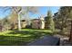 Backyard featuring a green lawn, mature trees, privacy fence, and a small storage shed at 2250 S Zang Ct, Lakewood, CO 80228