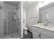 Modern bathroom features a glass enclosed shower, white vanity, and tile flooring at 2250 S Zang Ct, Lakewood, CO 80228