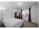 Cozy bedroom featuring plush carpeting, a large window, and a dark wood dresser at 2250 S Zang Ct, Lakewood, CO 80228