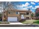 Charming two-story home features a well-maintained lawn, brick accents and an attached two-car garage at 2250 S Zang Ct, Lakewood, CO 80228