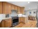 Modern kitchen boasts stainless steel appliances, granite countertops, and natural wood cabinets at 2250 S Zang Ct, Lakewood, CO 80228