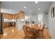 Inviting eat-in kitchen with wood cabinets, stainless steel appliances, and hardwood flooring at 2250 S Zang Ct, Lakewood, CO 80228