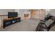 Cozy living room with dark entertainment center and a view to the dining room at 2250 S Zang Ct, Lakewood, CO 80228