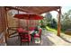 Cozy covered patio featuring stone floors, an outdoor dining table, and comfortable seating at 2250 S Zang Ct, Lakewood, CO 80228