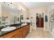 Bright bathroom featuring a double vanity with granite counters and walk-in shower at 8595 Gold Peak Dr # A, Highlands Ranch, CO 80130
