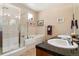 Bathroom with a glass shower, soaking tub, double sinks, and granite countertops at 8595 Gold Peak Dr # A, Highlands Ranch, CO 80130