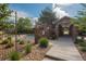 Community pool area with iron fence, greenery, and a stone archway entrance at 8595 Gold Peak Dr # A, Highlands Ranch, CO 80130