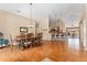 Open-concept dining area with hardwood floors and adjacent kitchen bar seating at 8595 Gold Peak Dr # A, Highlands Ranch, CO 80130