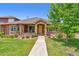 Inviting exterior of a single-story home with a stone archway and well-maintained landscaping at 8595 Gold Peak Dr # A, Highlands Ranch, CO 80130