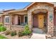 Cozy front porch features stone accents, a seating area, and a welcoming entrance at 8595 Gold Peak Dr # A, Highlands Ranch, CO 80130