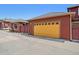 Exterior view of a detached single-car garage with a bright yellow door at 8595 Gold Peak Dr # A, Highlands Ranch, CO 80130