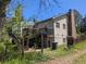 Back exterior featuring a deck, sunroom and siding at 1251 Lee St, Lakewood, CO 80215