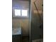 Compact bathroom with tiled walls, a sink, and a shower, perfect for functionality at 1251 Lee St, Lakewood, CO 80215