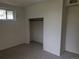 This carpeted bedroom offers an open closet and a window for natural light at 1251 Lee St, Lakewood, CO 80215