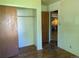Cozy bedroom featuring a closet for storage and classic hardwood floors at 1251 Lee St, Lakewood, CO 80215