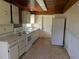 Compact kitchen awaiting renovation, featuring essential appliances and ample cabinet space at 1251 Lee St, Lakewood, CO 80215