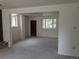An open living room features neutral paint, new carpet, and natural light from multiple windows at 1251 Lee St, Lakewood, CO 80215