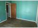 Cozy room featuring wood floors and a door with a view to another room at 1251 Lee St, Lakewood, CO 80215