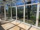 Bright sunroom with glass ceiling and walls offers stunning views of the backyard and ample natural light at 1251 Lee St, Lakewood, CO 80215