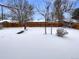 Snow-covered backyard with wooden fence and mature trees at 3569 W 89Th Ave, Westminster, CO 80031