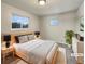 Virtually staged bedroom with light walls and a wood bed frame at 3569 W 89Th Ave, Westminster, CO 80031